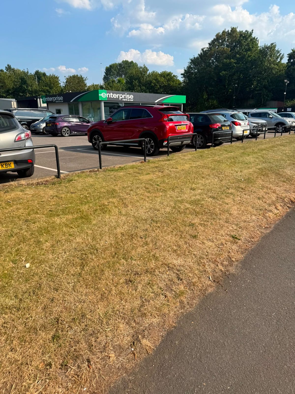 Mown verge beside a commercial car park