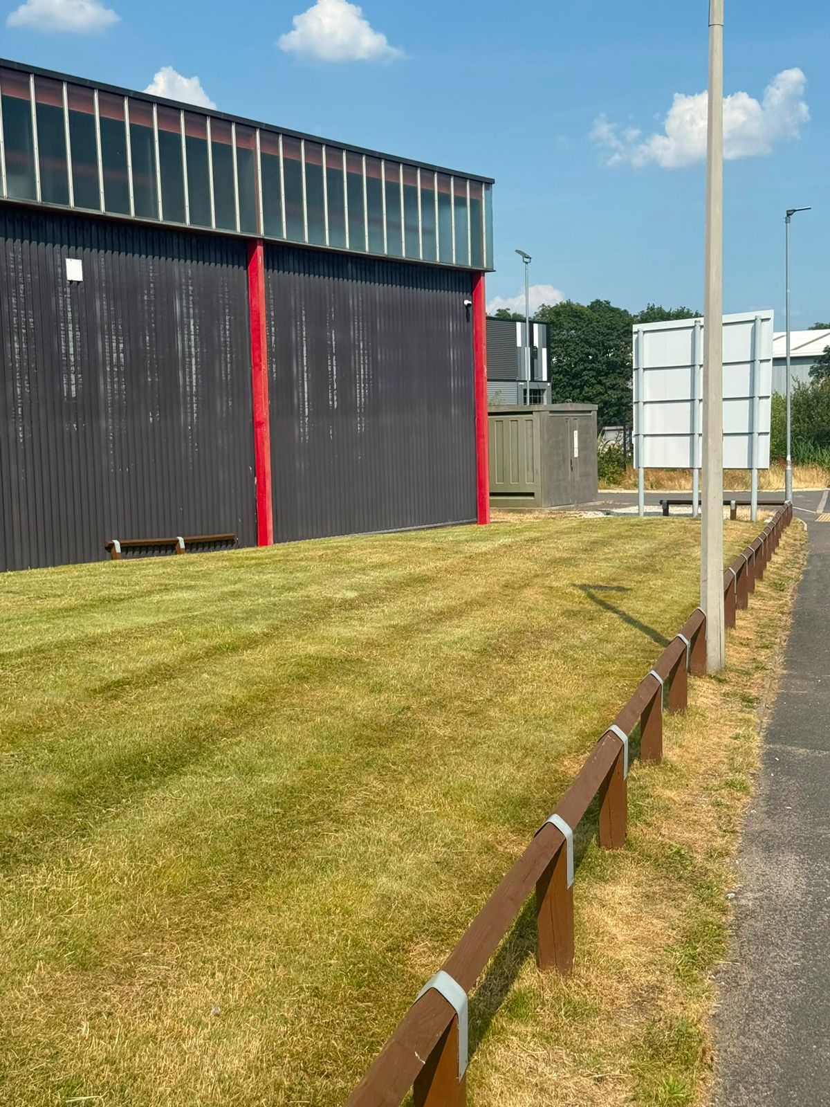 Striped lawn beside a commercial unit